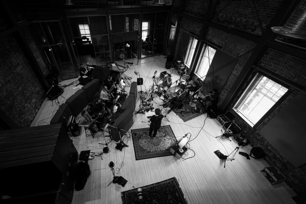 Aerial black and white shot of Cory Weeds' band rehearsing in a warehouse studio, by Steve Mynett