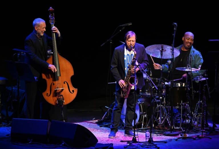 Crosscurrents Trio on the Barbican stage, mid-set, under purple lights.