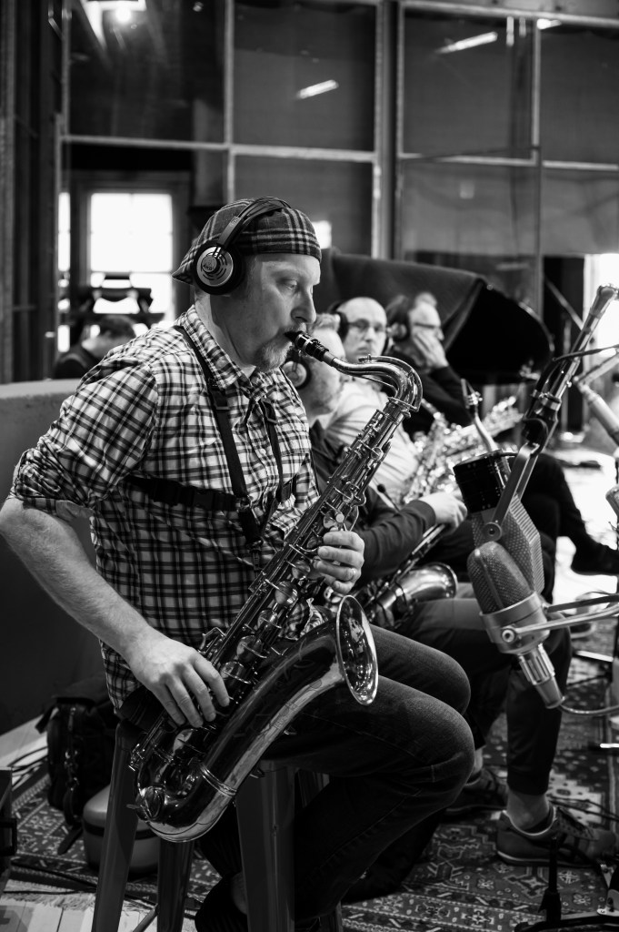 Cory Weeds playing saxophone in studio. Black & white photo by Steve Mynett.