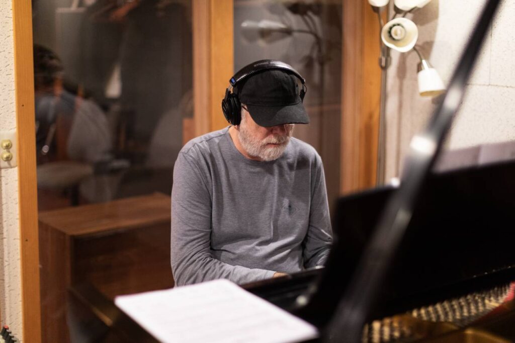 Bill O'Connell sits at the piano.