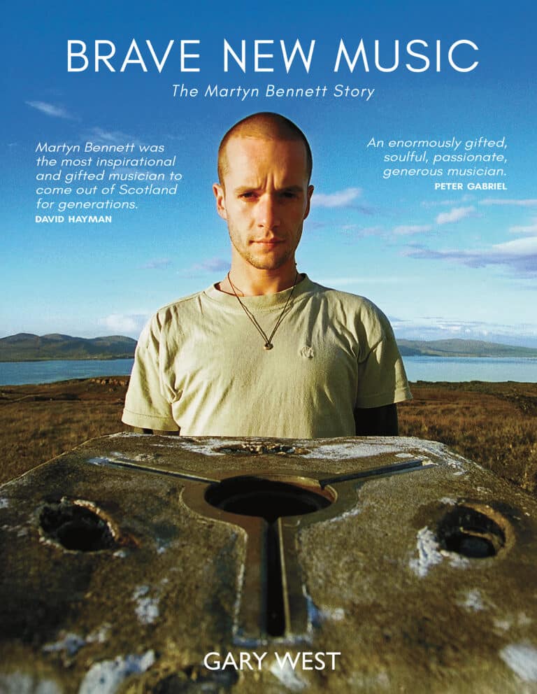 The cover of 'Brave New Music.' Martyn Bennett stands in a sunny Scottish countryside landscape.