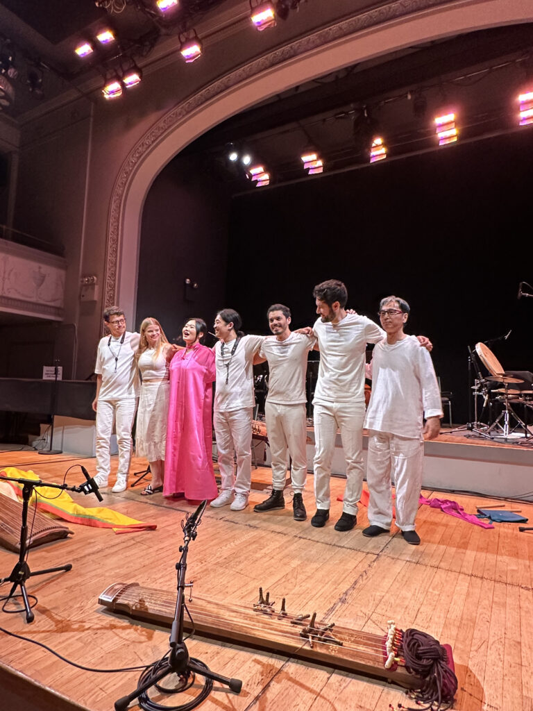 DoYeon Kim at the end of gig on stage with all the other musicians in a line