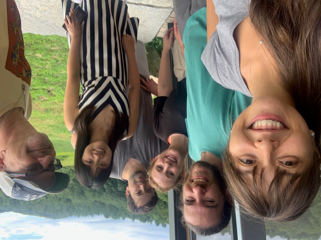 Musicians on Balls of Simplicity album taking a selfie outside with green in the background
