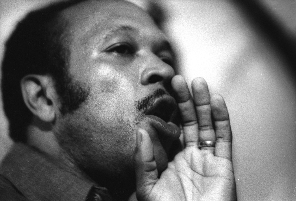 Black and white close-up photo of Les McCann singing.