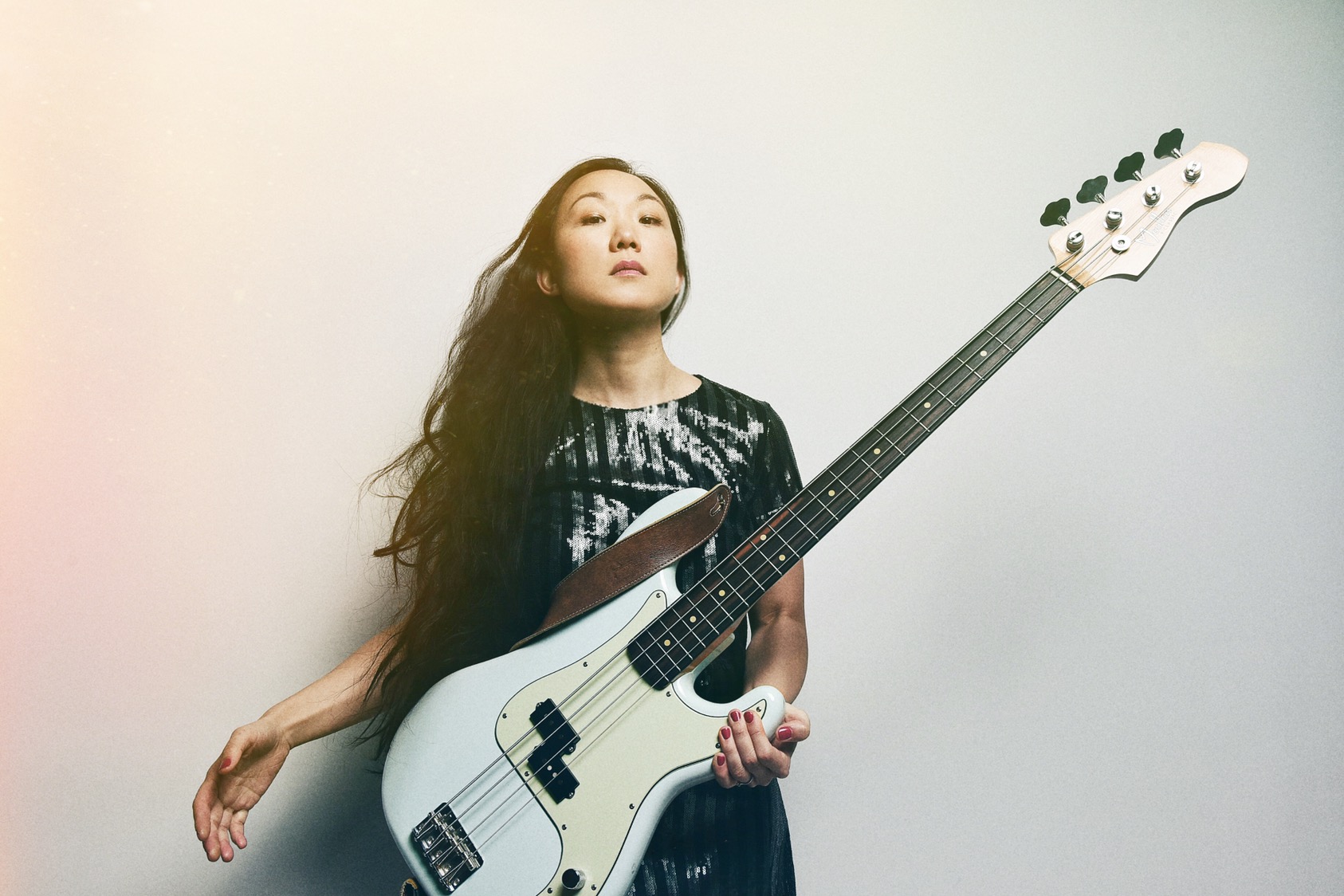 Linda May Han Oh holding electric bass