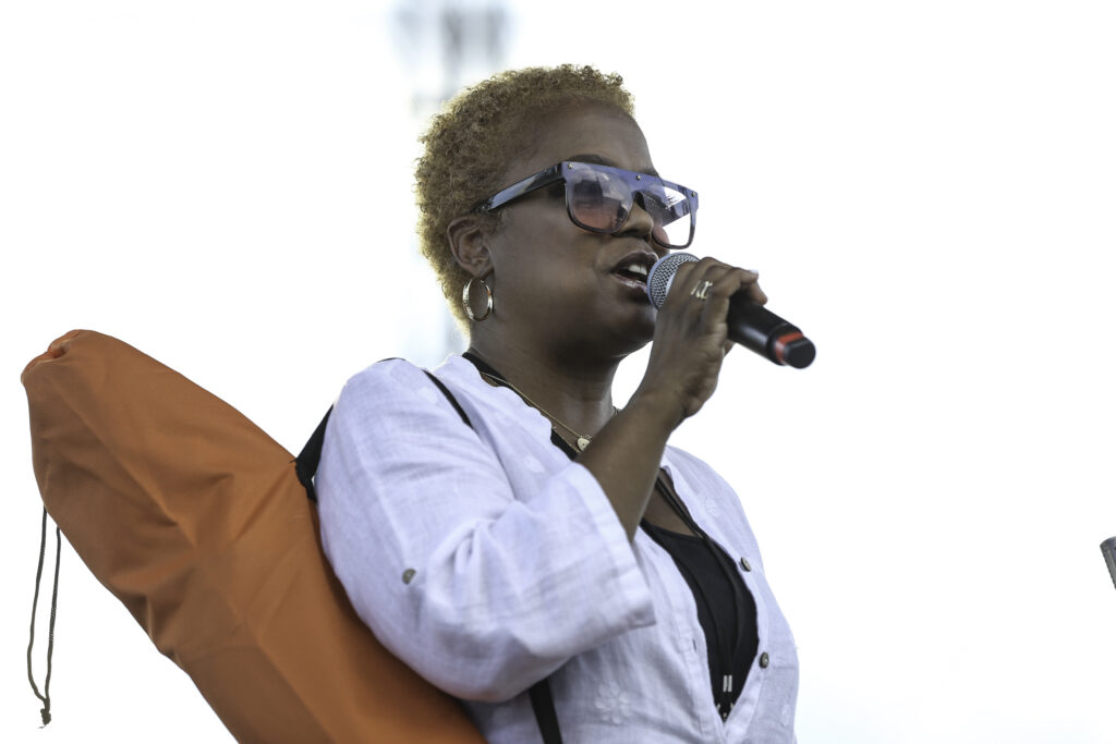 Sunny Sumter talking into a microphone at the DC JazzFest