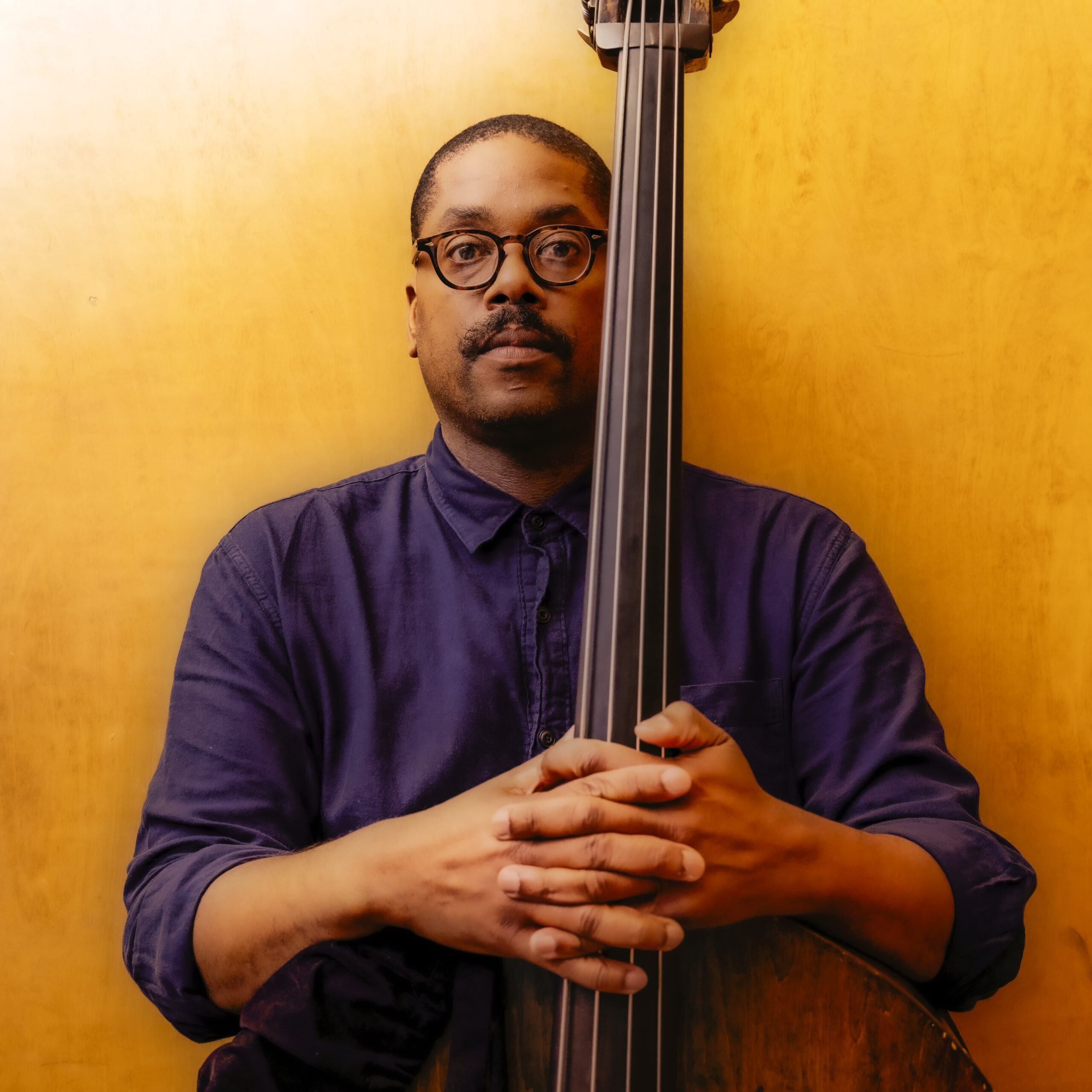 Vicente Archer staring into the camera holding double bass